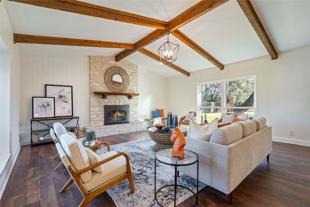 living area featuring vaulted ceiling with beams, a chandelier, wood finished floors, and a stone fireplace