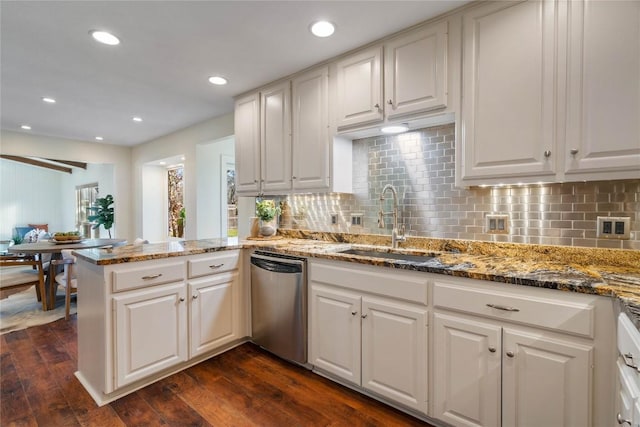 kitchen featuring a sink, white cabinets, dark wood finished floors, and stainless steel dishwasher