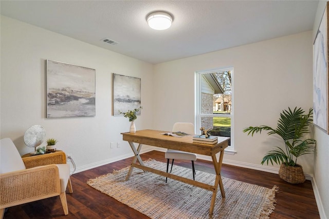 home office featuring baseboards, visible vents, and wood finished floors