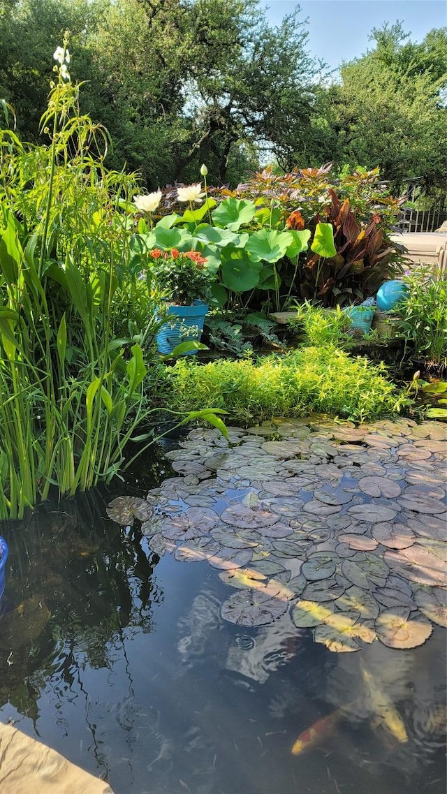 exterior details with a garden pond