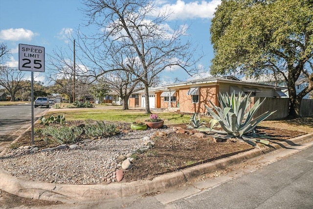 single story home featuring stone siding and fence