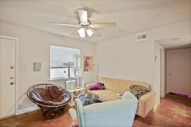 living room with baseboards, a textured ceiling, visible vents, and a ceiling fan