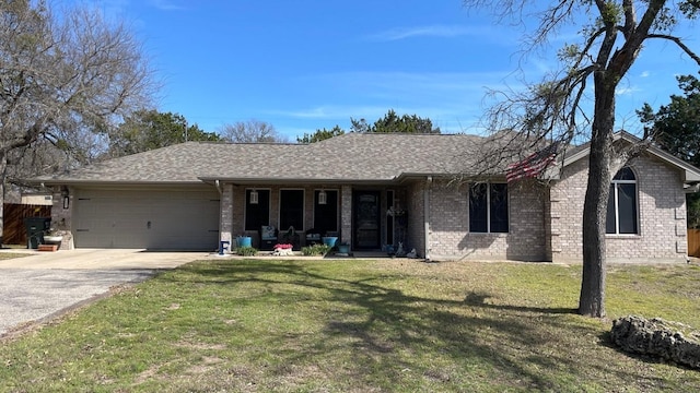 ranch-style home with a garage, concrete driveway, a front lawn, and brick siding