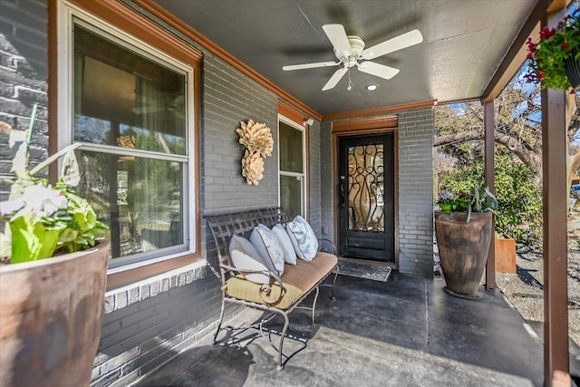 entrance to property with brick siding and ceiling fan