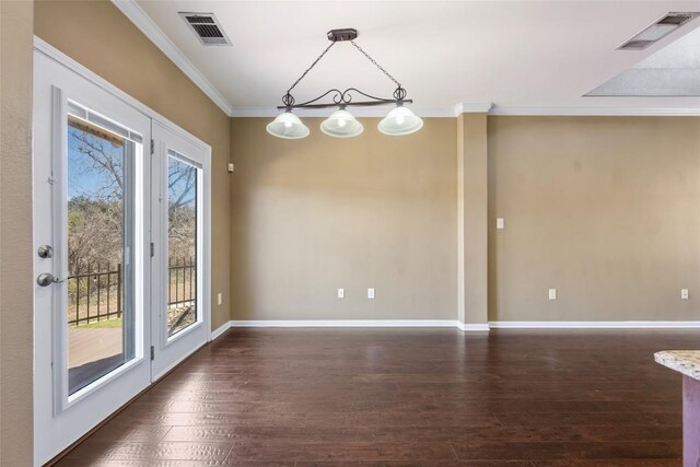 unfurnished dining area with dark wood-style floors, ornamental molding, and visible vents