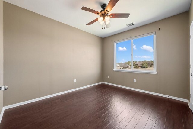 unfurnished room featuring a ceiling fan, baseboards, visible vents, and dark wood-style flooring