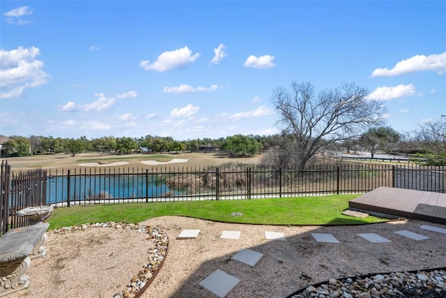 view of yard with a water view and fence