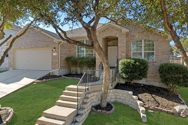 ranch-style home with a garage, a front lawn, concrete driveway, and brick siding