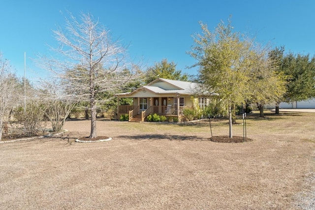 view of front of home featuring covered porch and a front lawn