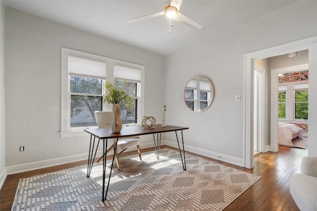 office with baseboards, hardwood / wood-style floors, a ceiling fan, and a healthy amount of sunlight