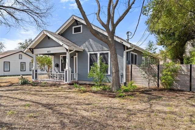 bungalow-style house featuring fence and a porch