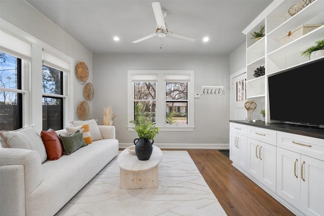 living room featuring recessed lighting, ceiling fan, baseboards, and dark wood-type flooring