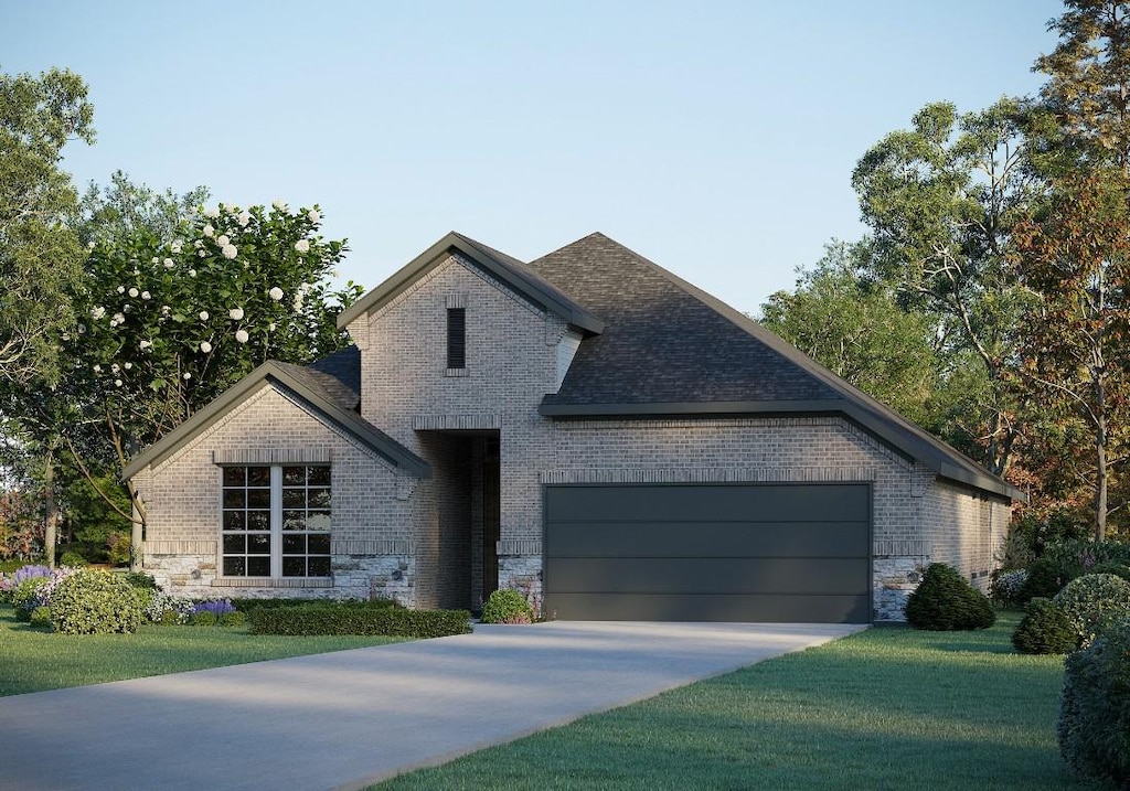 view of front of house featuring brick siding, concrete driveway, an attached garage, a front yard, and stone siding