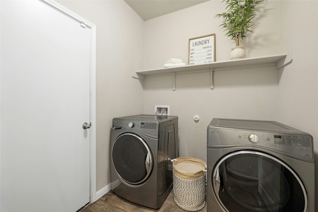 laundry room featuring laundry area, baseboards, wood finished floors, and independent washer and dryer