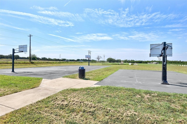 view of basketball court with community basketball court and a yard