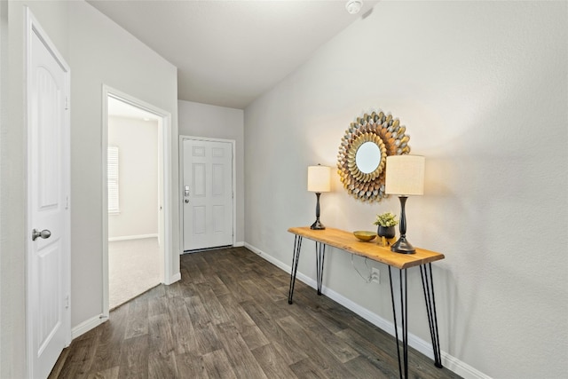 entryway with dark wood-type flooring and baseboards