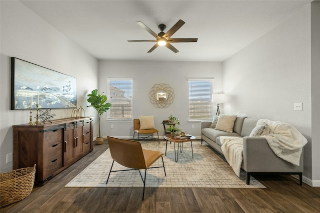 living area with ceiling fan, dark wood finished floors, and baseboards