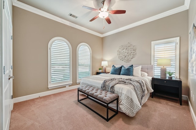 carpeted bedroom featuring baseboards, ceiling fan, visible vents, and crown molding