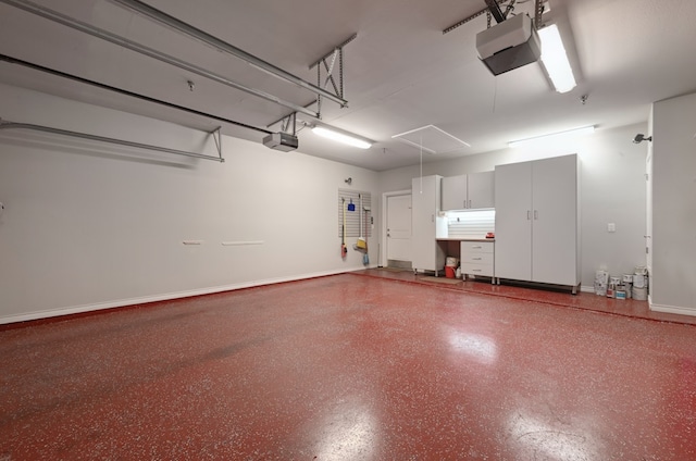 garage featuring baseboards and a garage door opener