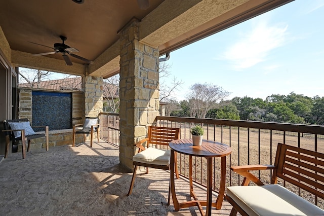 view of patio / terrace with a balcony and a ceiling fan