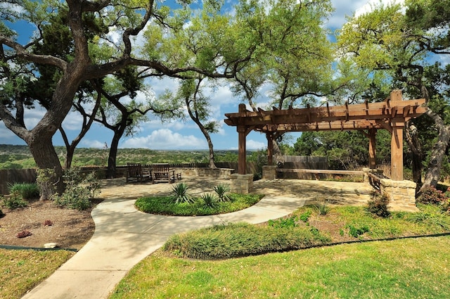 surrounding community with a patio area, fence, and a pergola