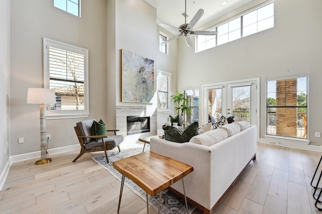 living room featuring light wood finished floors, plenty of natural light, and french doors