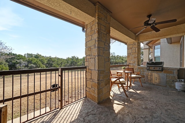 balcony featuring ceiling fan, an outdoor kitchen, and grilling area