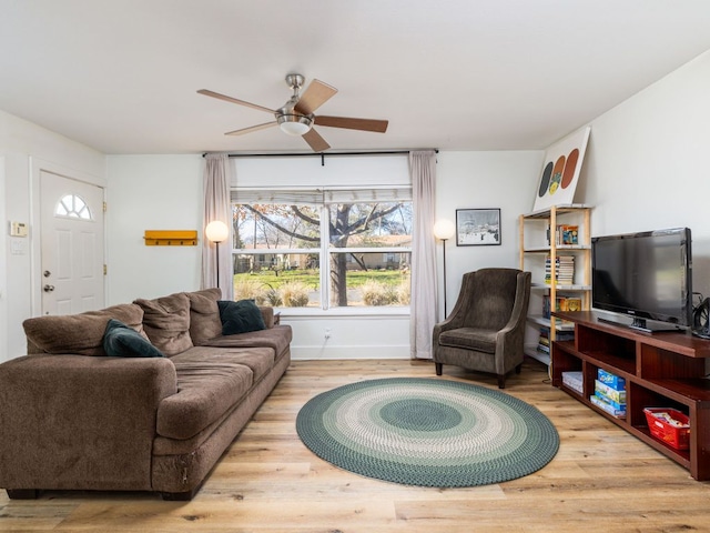 living room featuring wood finished floors and a ceiling fan