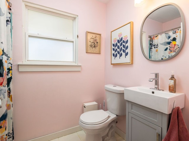 full bath featuring tile patterned flooring, baseboards, vanity, and toilet