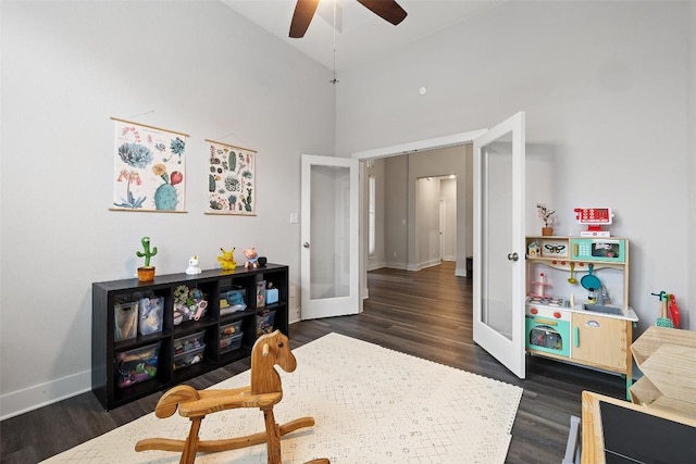 interior space with ceiling fan, lofted ceiling, dark wood-style flooring, baseboards, and french doors