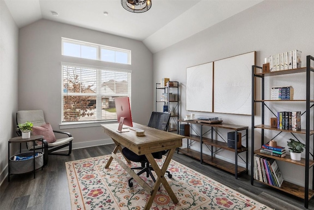 office space featuring baseboards, vaulted ceiling, and dark wood finished floors