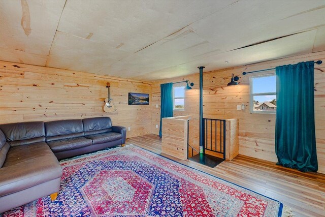 7875 W Fitzhugh Rd, Dripping Springs, TX 78620 - living room featuring healthy amount of natural light, wood finished floors, and wooden walls