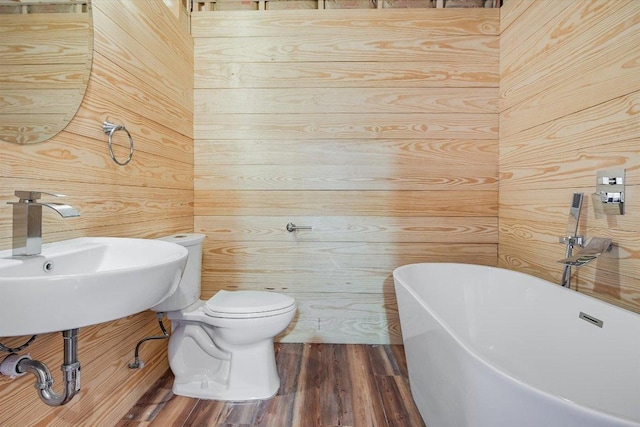 7875 W Fitzhugh Rd, Dripping Springs, TX 78620 - bathroom featuring a freestanding bath, wood finished floors, and wooden walls