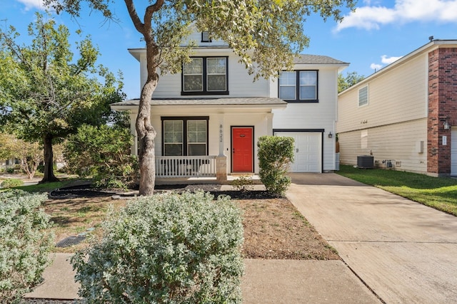 view of front facade with central AC unit, driveway, a porch, and an attached garage