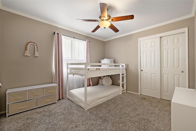 bedroom featuring baseboards, ceiling fan, crown molding, carpet floors, and a closet