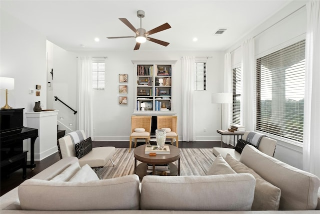 living area featuring recessed lighting, visible vents, a ceiling fan, wood finished floors, and baseboards