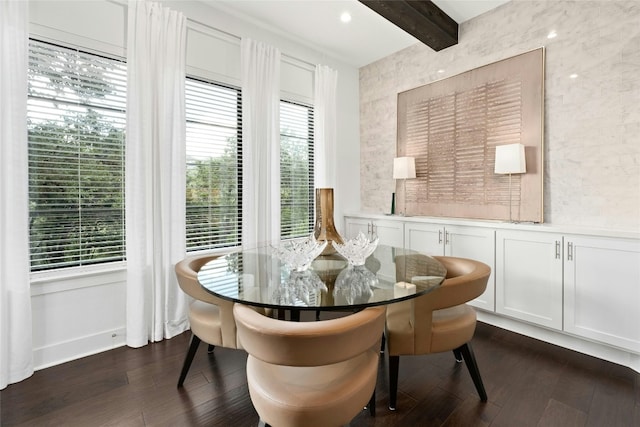 dining space featuring dark wood-type flooring and beamed ceiling