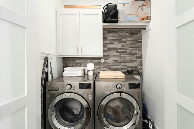 laundry room with cabinet space and washer and clothes dryer