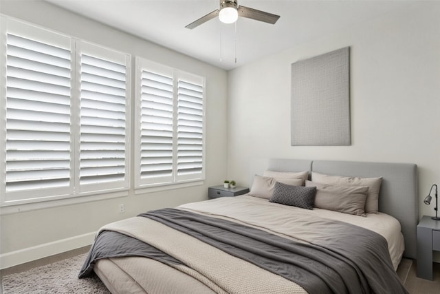 bedroom featuring baseboards and a ceiling fan