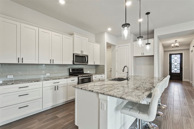 211 Singing Sumac Way, San Marcos, TX 78666 - kitchen with stainless steel appliances, dark wood-style flooring, white cabinets, and recessed lighting