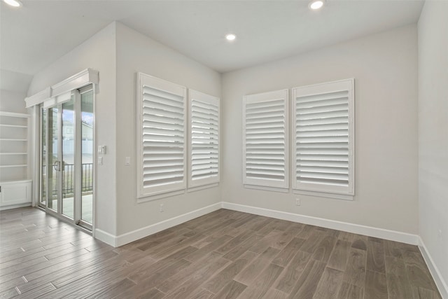 unfurnished room with recessed lighting, baseboards, and wood finished floors