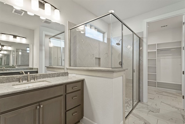 full bath with vanity, visible vents, marble finish floor, and a stall shower