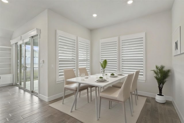 dining space with recessed lighting, baseboards, and wood finished floors