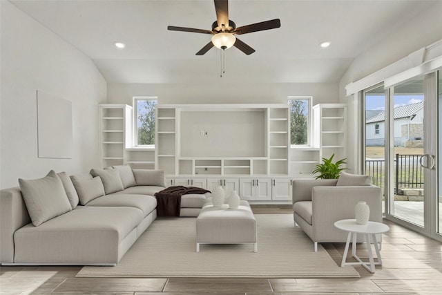 living area with recessed lighting, ceiling fan, lofted ceiling, and light wood-style floors
