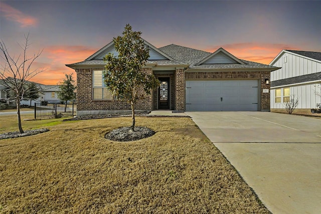 view of front facade featuring concrete driveway, brick siding, and a garage