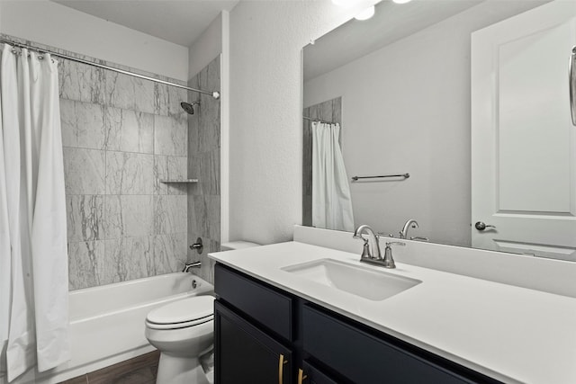bathroom featuring vanity, toilet, wood finished floors, and shower / tub combo