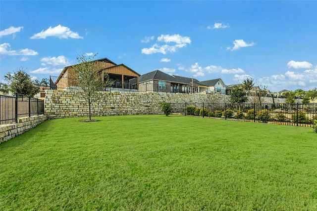 view of yard with a fenced backyard and a residential view