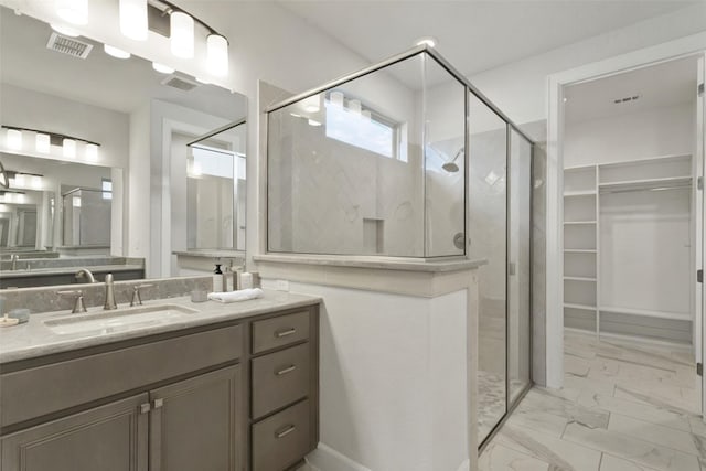211 Singing Sumac Way, San Marcos, TX 78666 - bathroom with a stall shower, vanity, a walk in closet, and marble look tiles