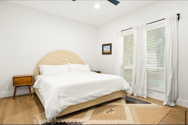 bedroom featuring ceiling fan, baseboards, wood finished floors, and recessed lighting