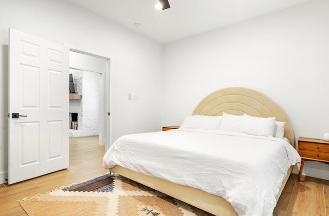 bedroom featuring light wood-type flooring and a ceiling fan